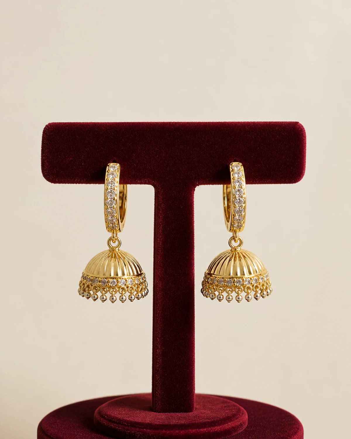 Pair of polished bell jhumka earrings on crystal-set crescent hoops
