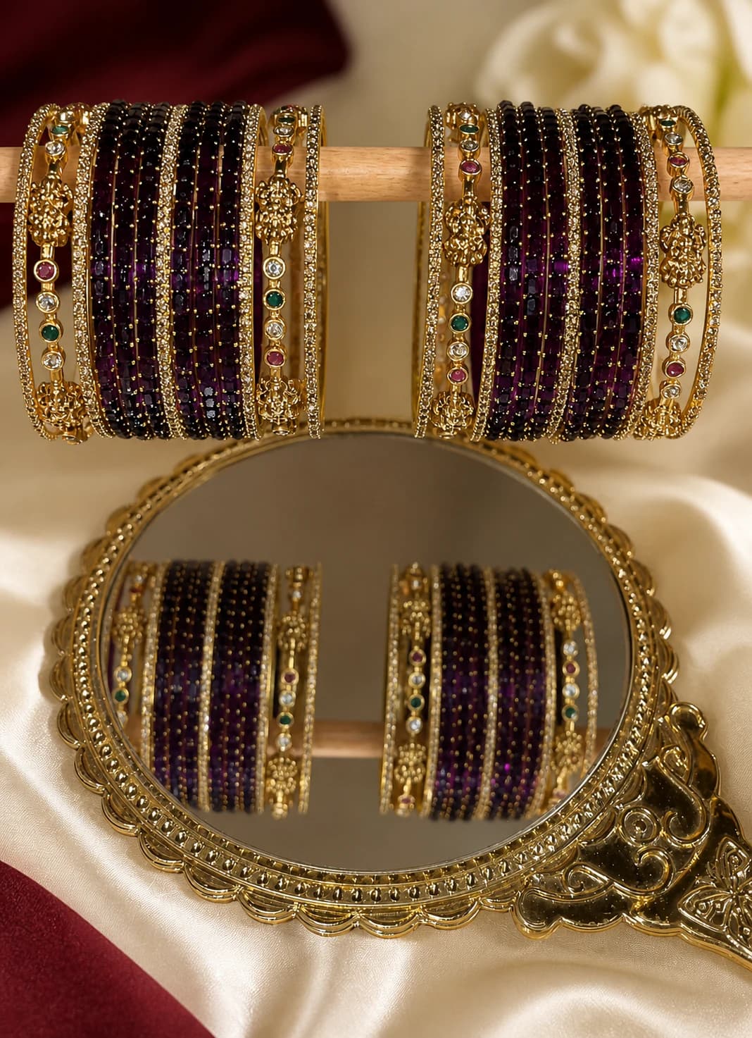 Two coordinated deep plum bangle stacks with coloured stones