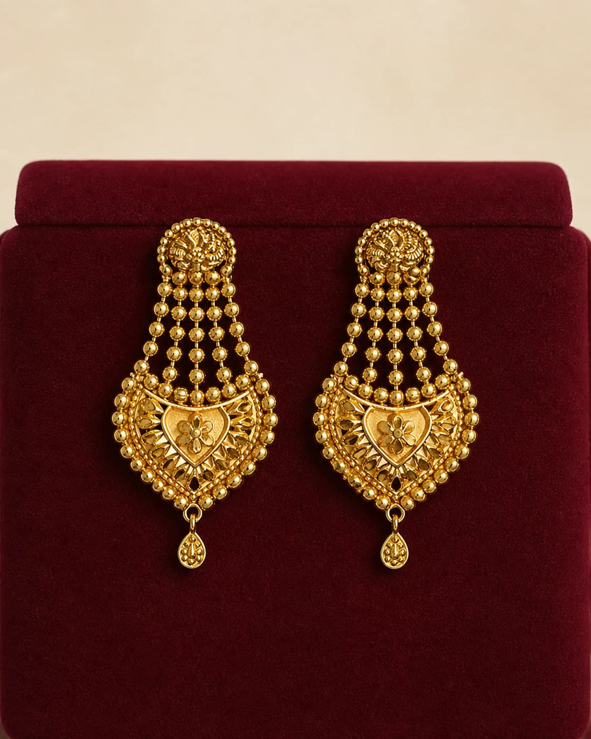 Pair of warm-tone drop earrings with beaded cascades and heart-shaped centres