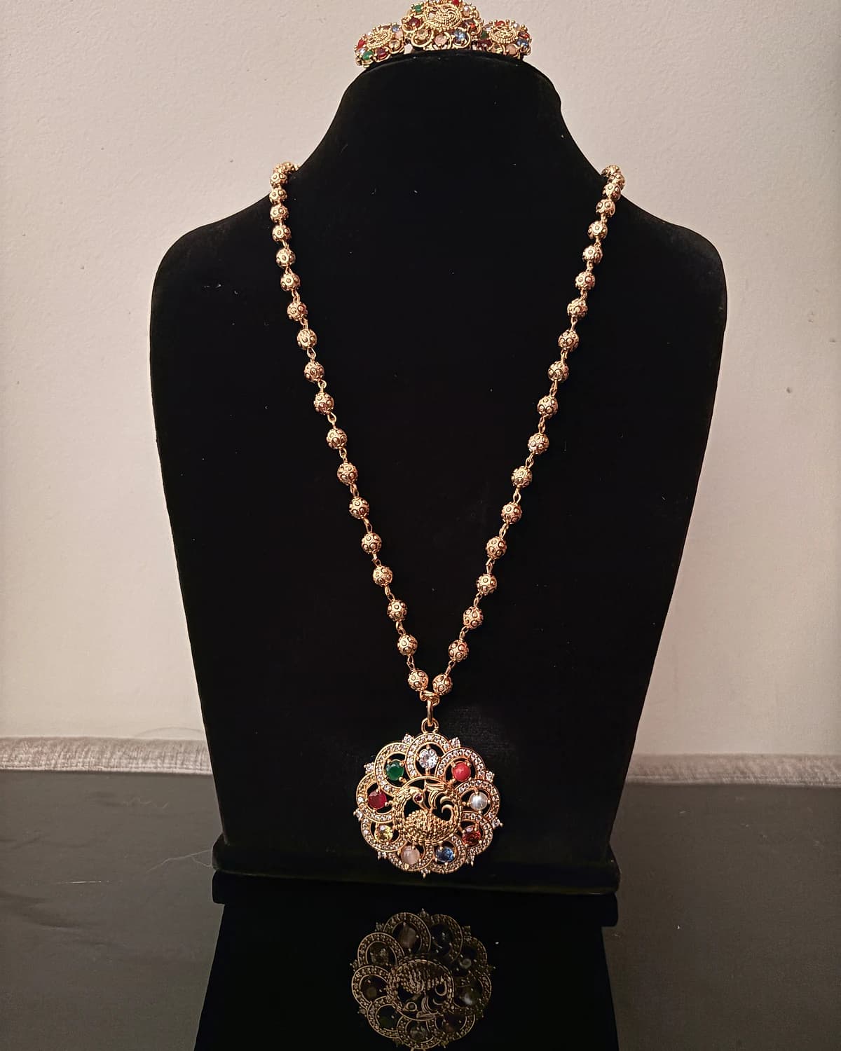 Full-length view of the peacock pendant necklace