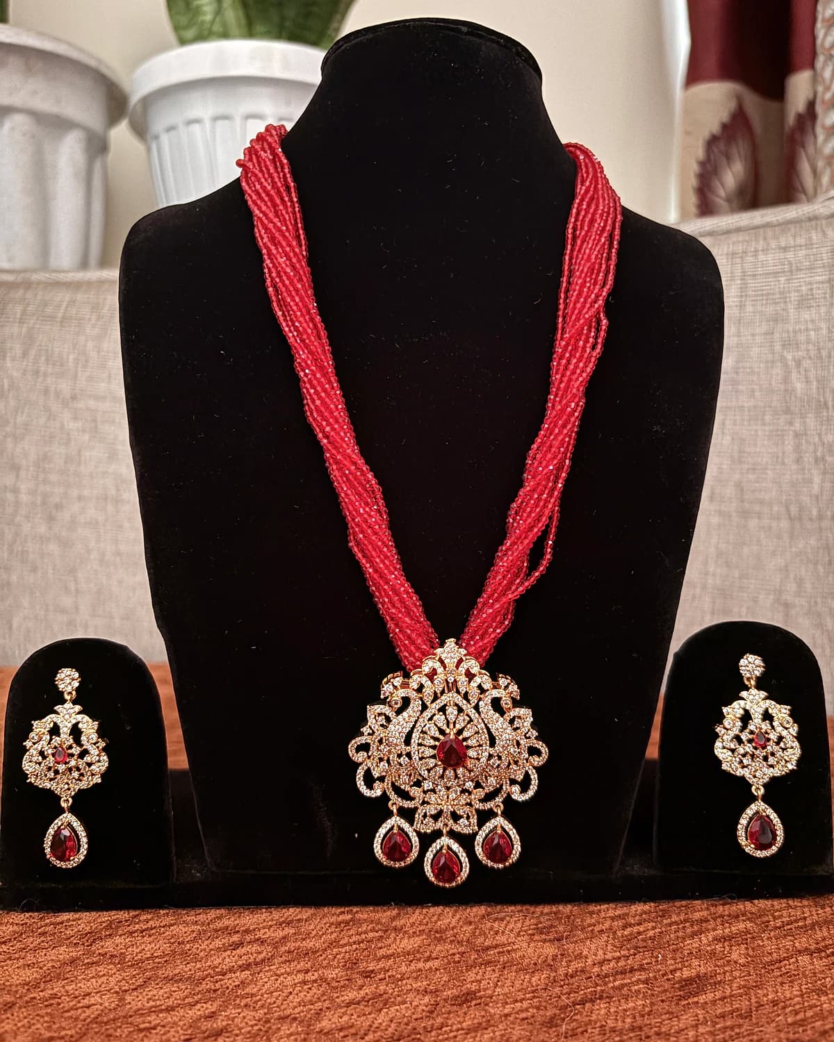 Straight-on view of the red bead necklace set