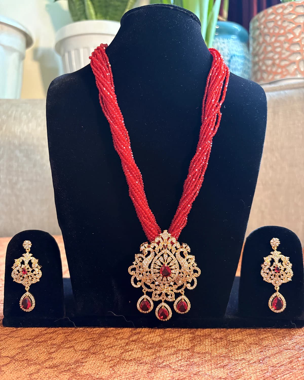 Full display view of the red bead necklace with both matching earrings