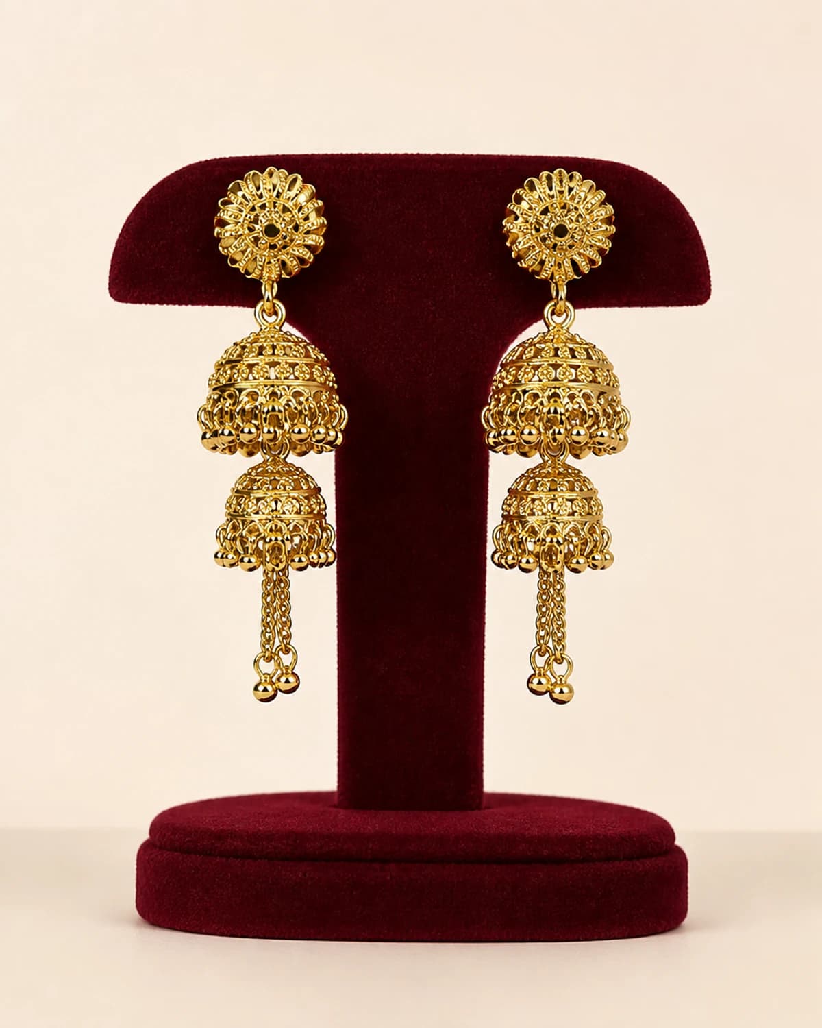 Pair of long warm-tone earrings with two tiered bell drops