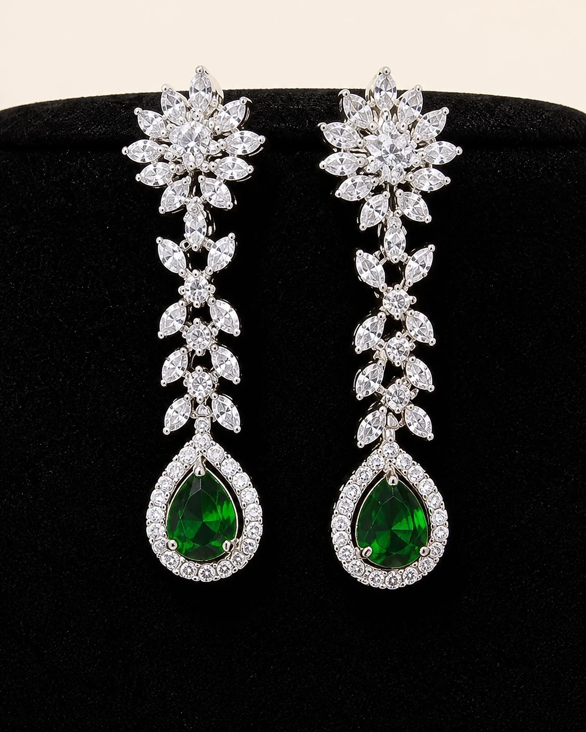 Close detail of the matching crystal and green teardrop earrings