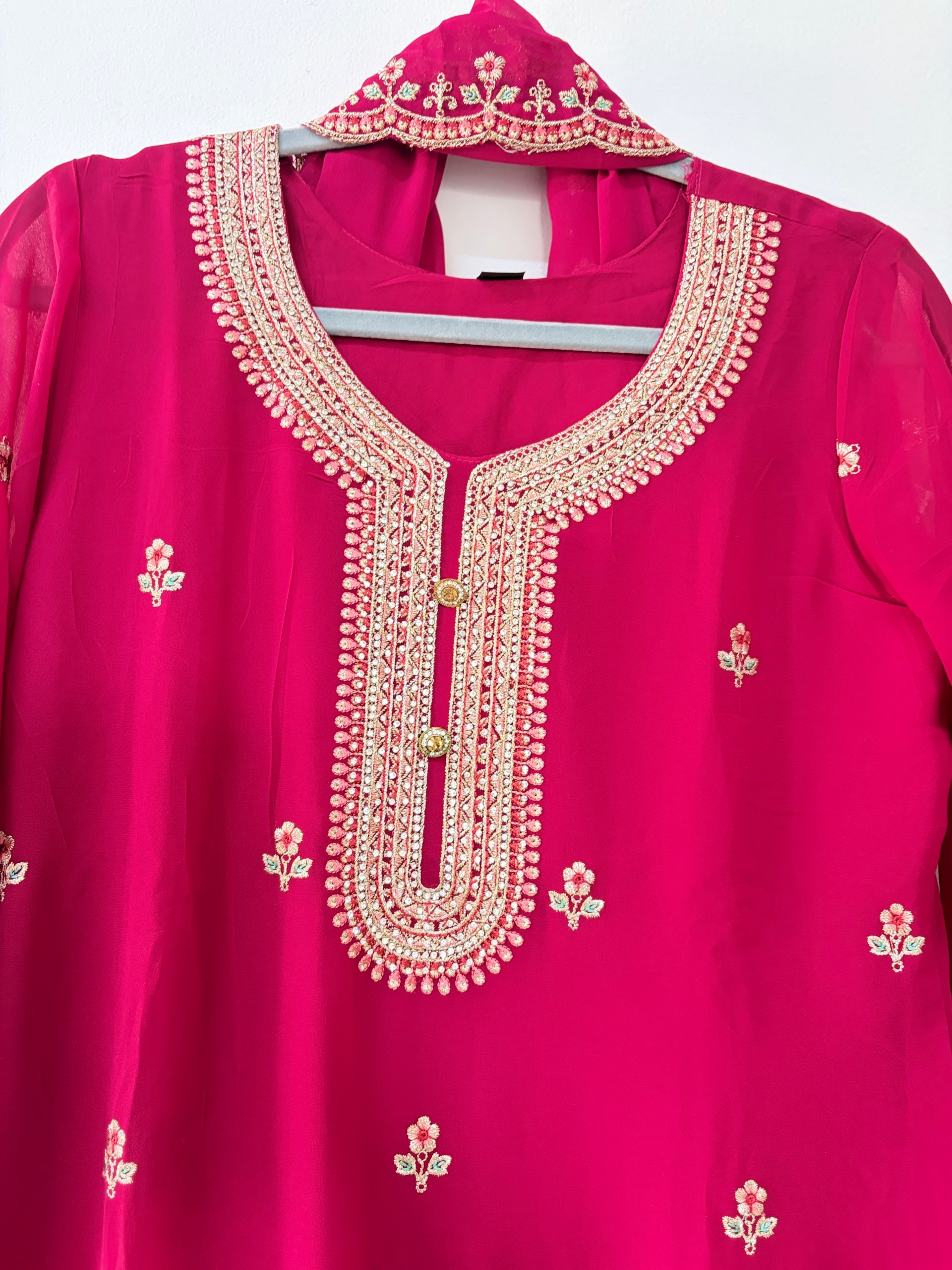 Original fuchsia kurta neckline showing the exact floral embroidery and buttons