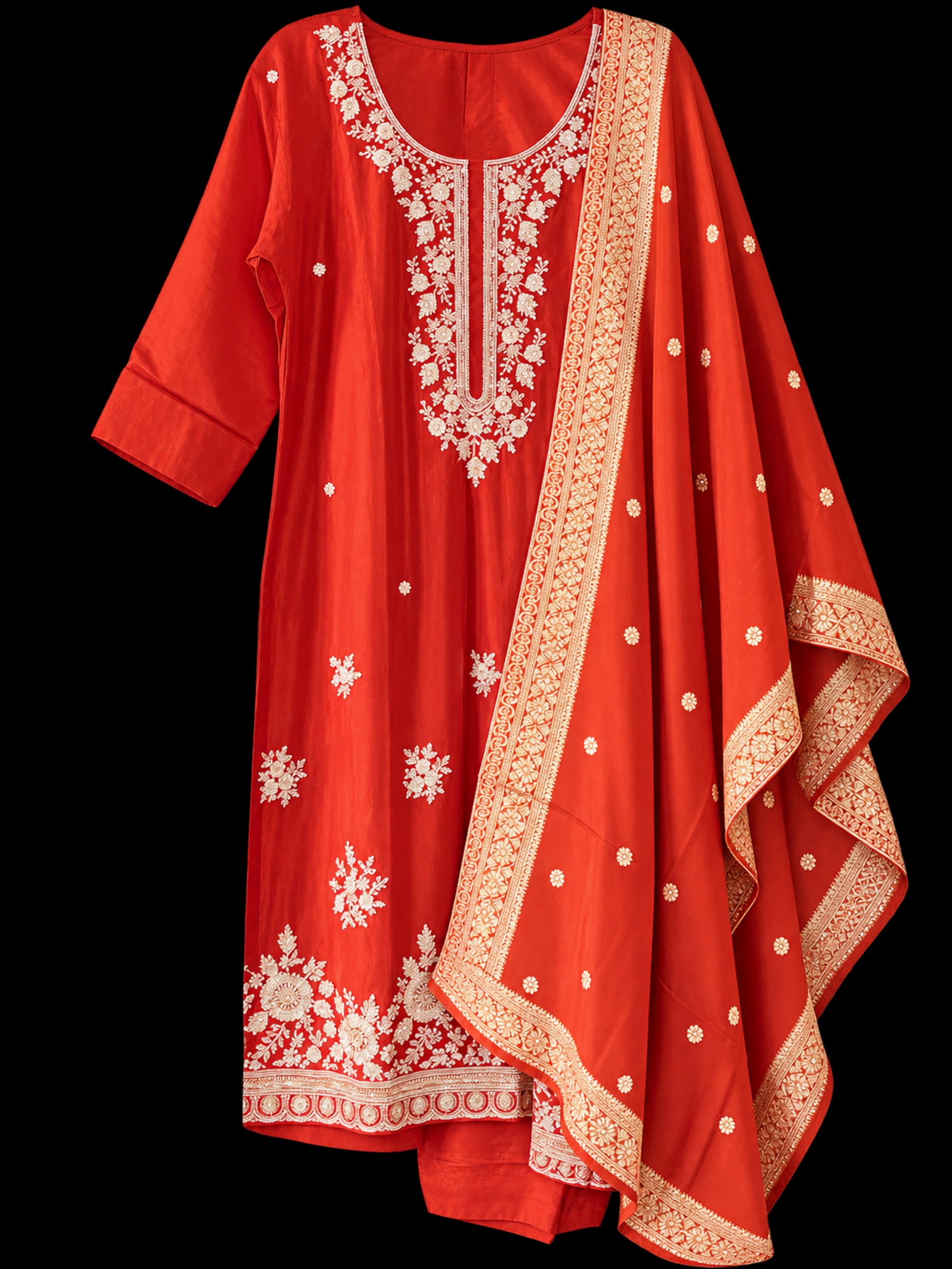 An orange-red kurta suruwal with floral embroidery and a matching dupatta with a broad gold border.
