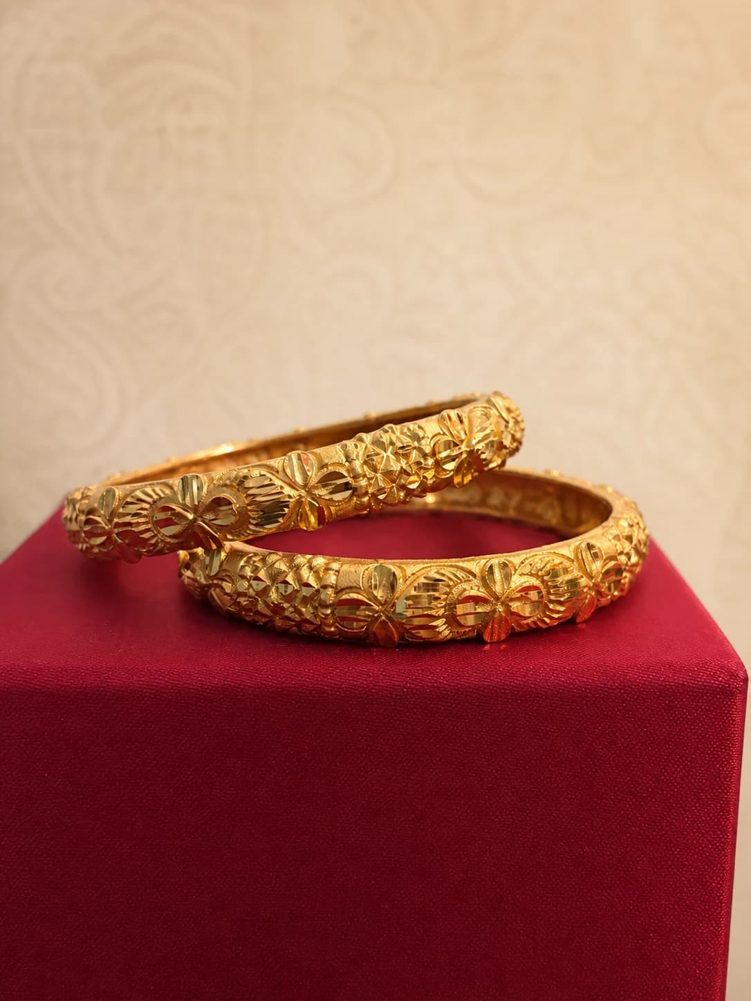 Close detail of the floral and geometric side of a traditional bangle pair