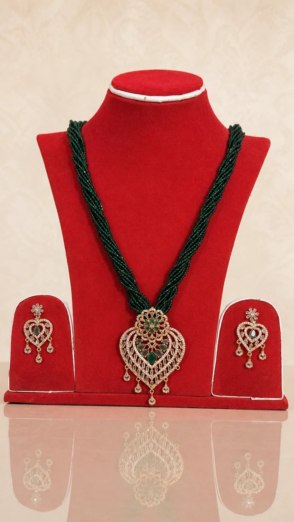 Green multi-strand necklace with an ornate pendant and matching earrings