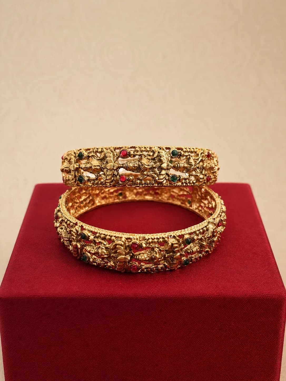 Ornate traditional bangle pair with raised relief and red and green details