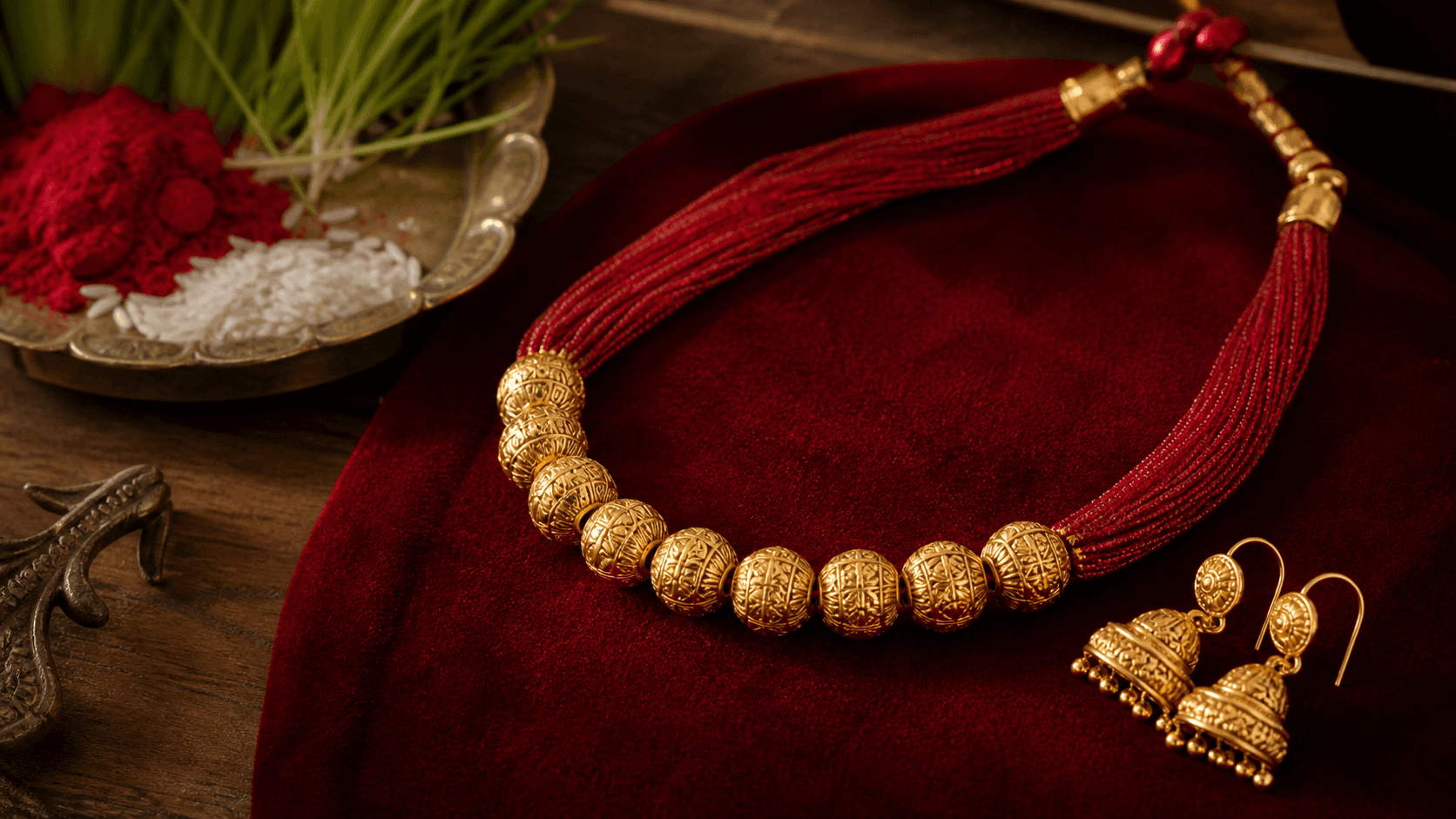 Nine-bead Naugedi and traditional gold jhumka arranged beside Dashain tika and jamara