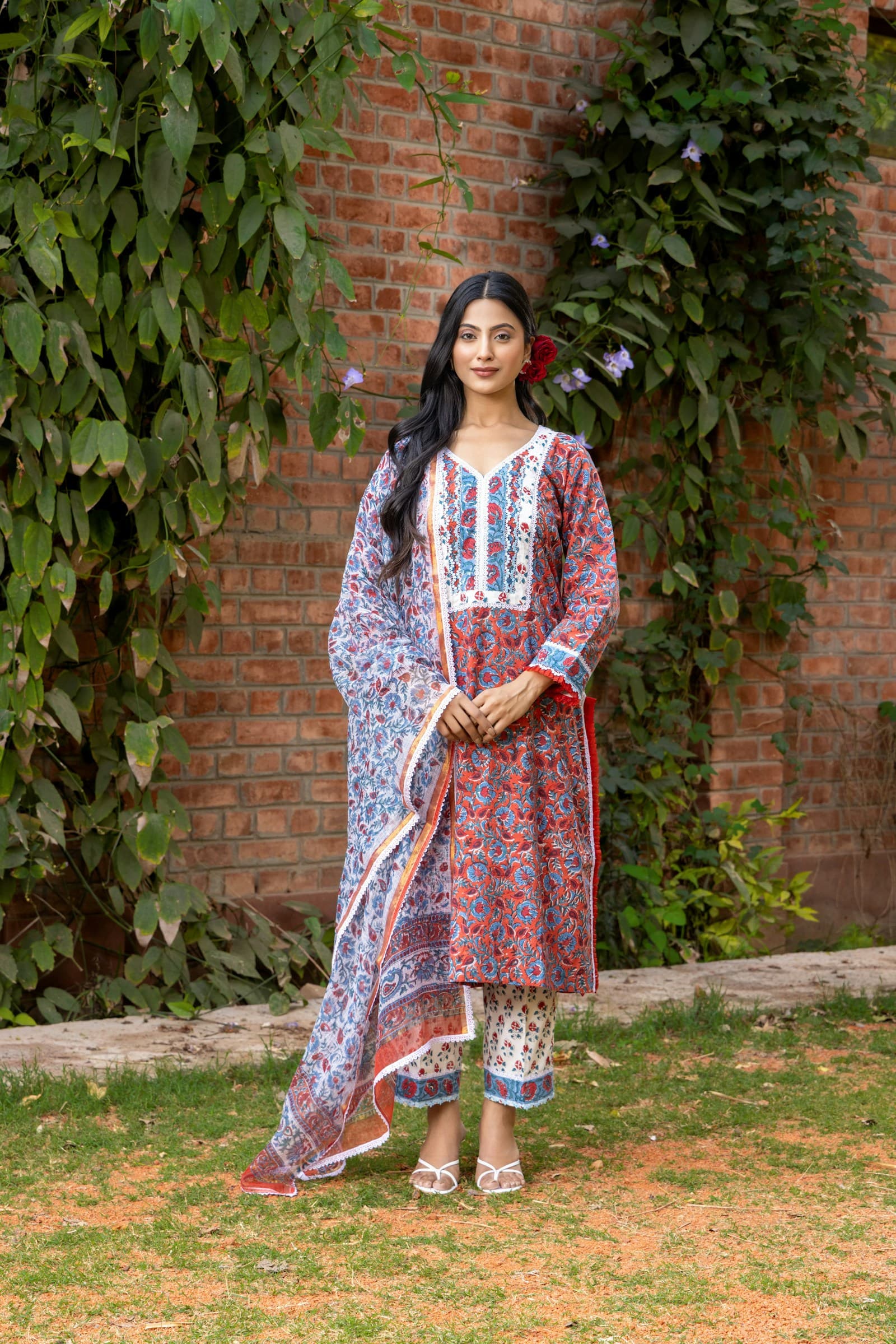 Woman wearing a red and blue block-printed cotton kurta and dupatta